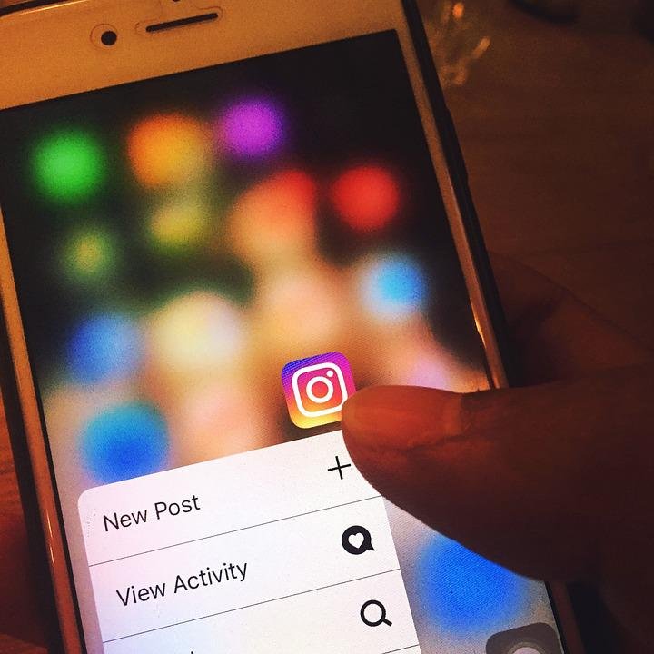 A close-up of a person about to add a new post to Instagram on their smartphone.